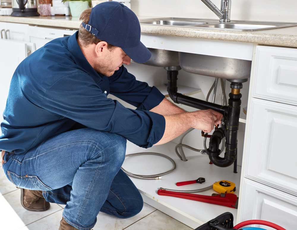 exeter plumber working on a drain repair job